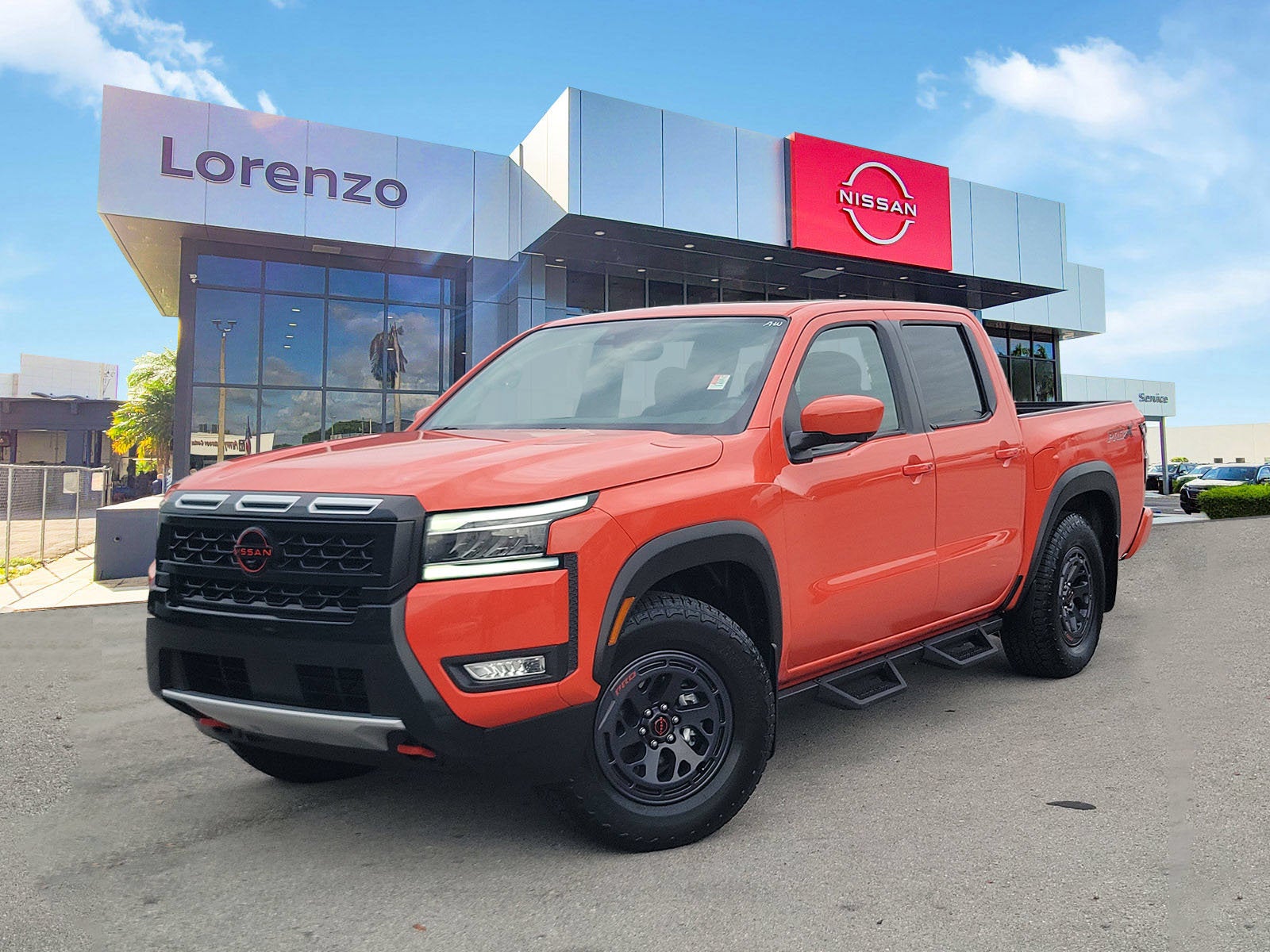 2025 Nissan Frontier PRO-X in Afterburn Orange — front three-quarter view